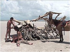 kinky brazilian woman gets two schlongs on the beach