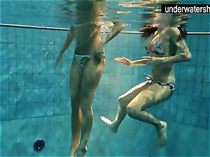 two uber-sexy amateurs showcasing their figures off under water